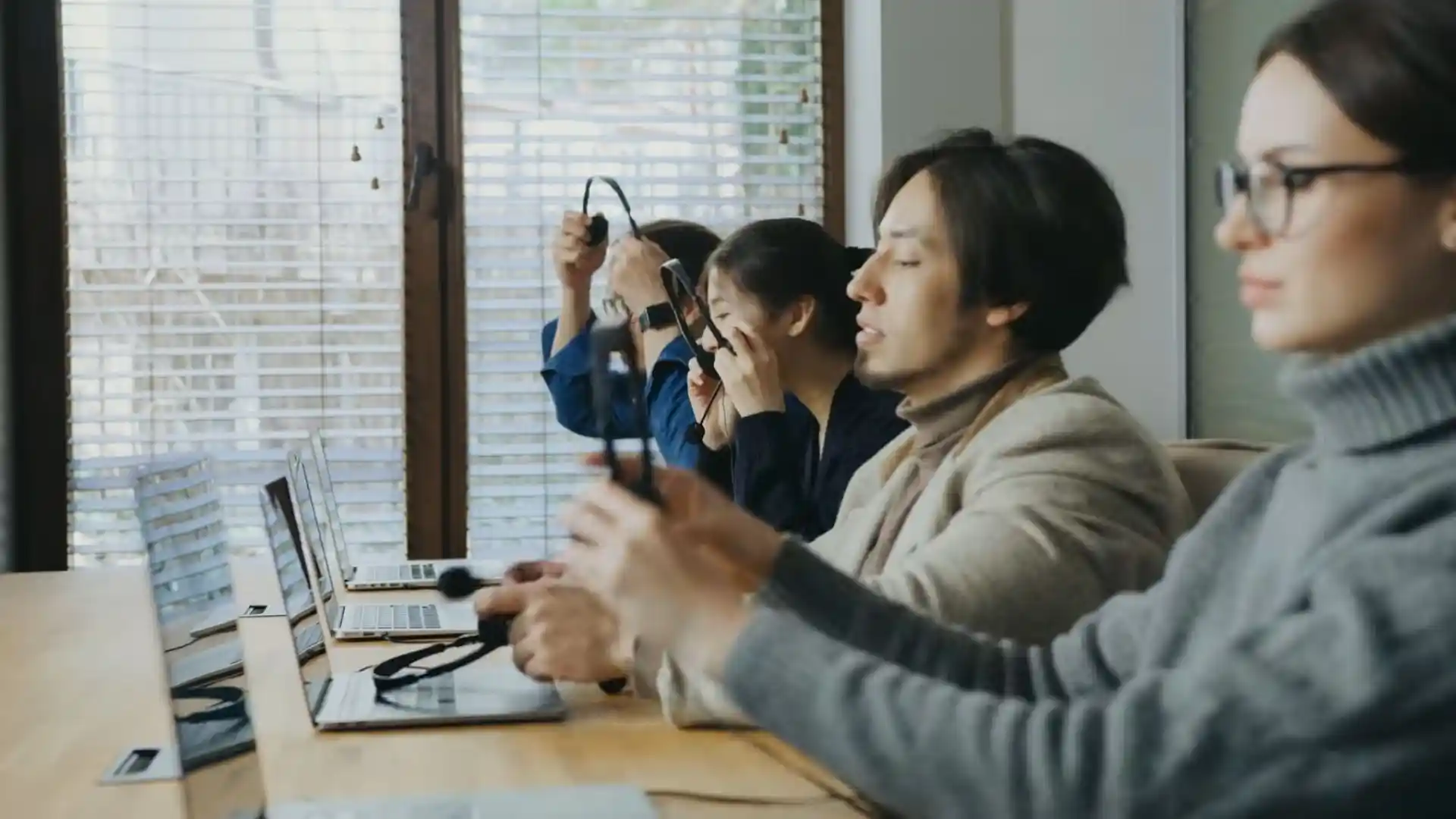 Dispatch team members putting on headsets at their desks