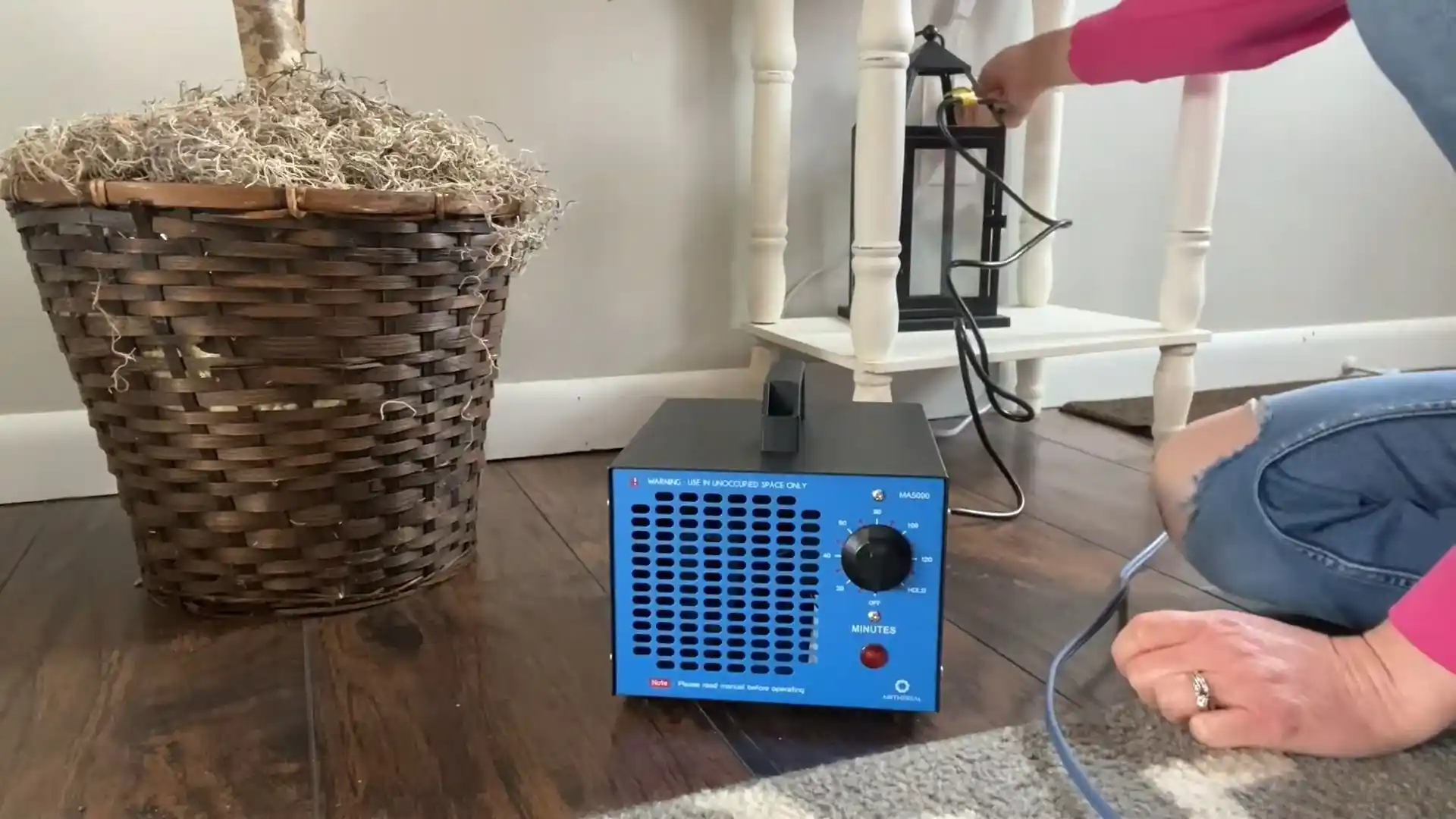 Ozone generator set up on a floor for fire and smoke odor treatment in a living room