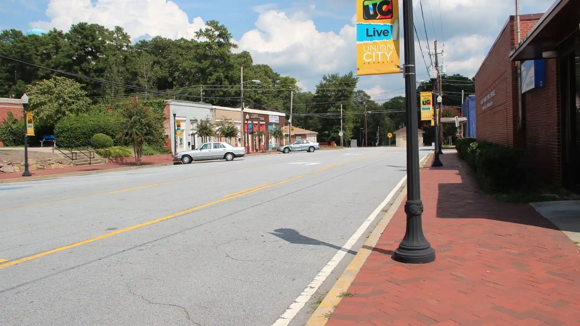 Street view of downtown Union City, GA with local storefronts and banners